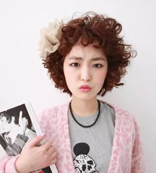 女生短发爆炸头发型,蓬松卷发遮盖部分面容,打